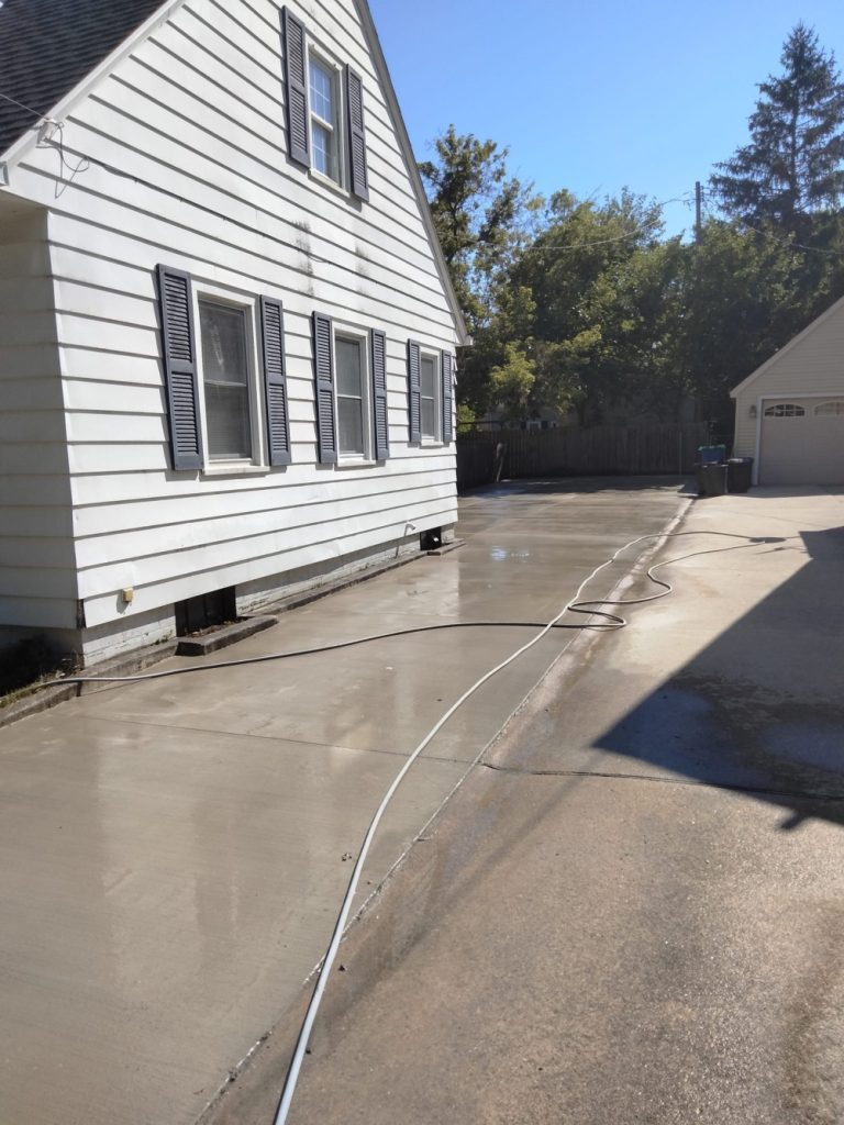 Picture of a home driveway with finished concrete.