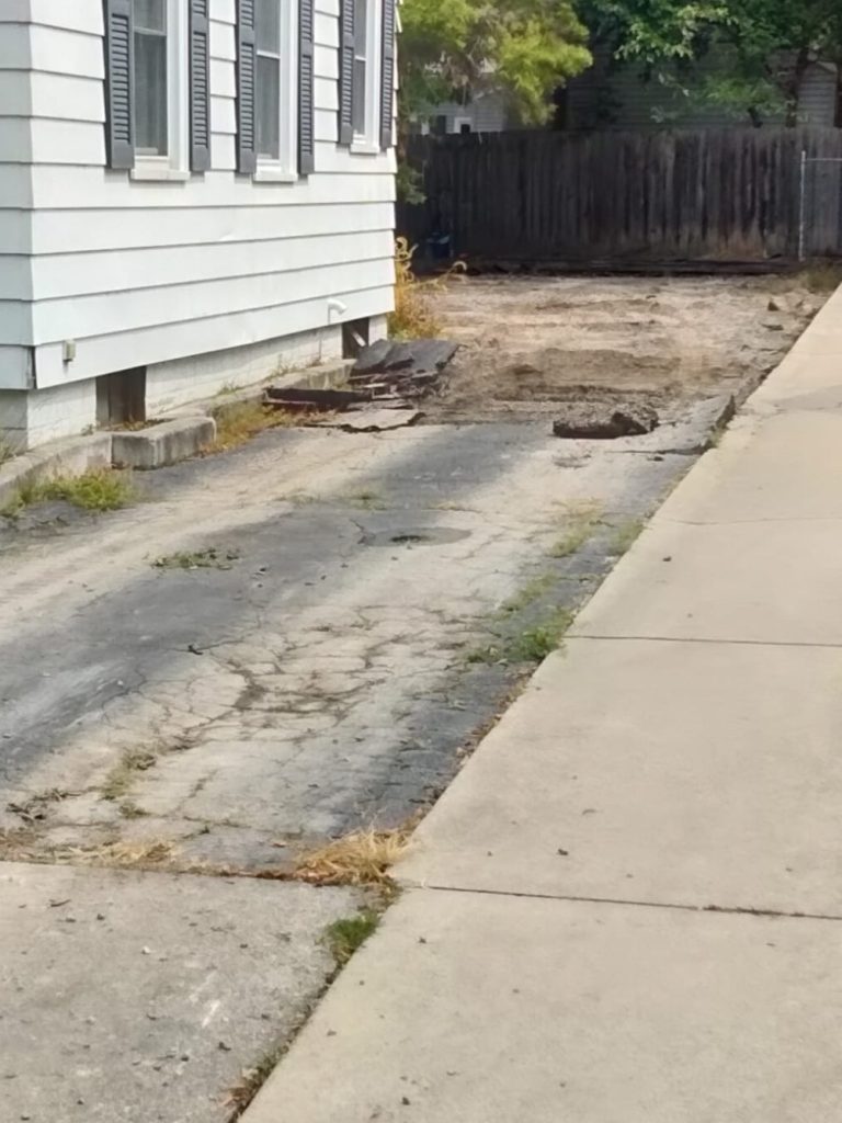 Before picture of a home driveway before renovation.