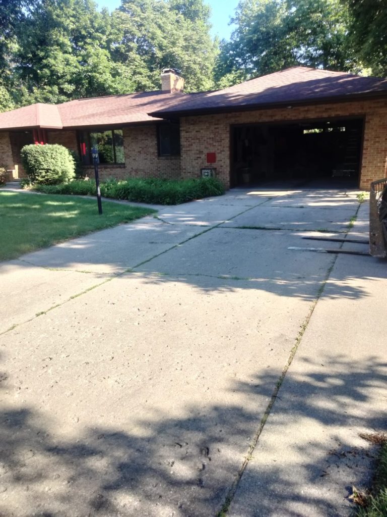 Before picture of a home driveway before renovation.