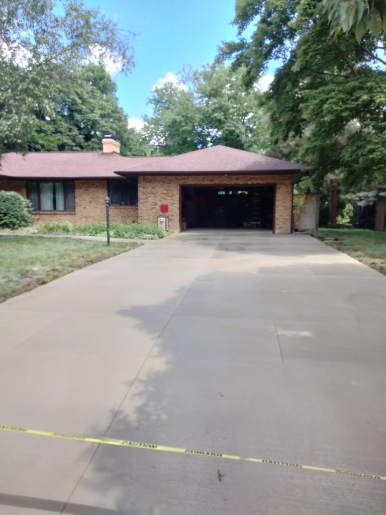 Picture of a home driveway with finished concrete.