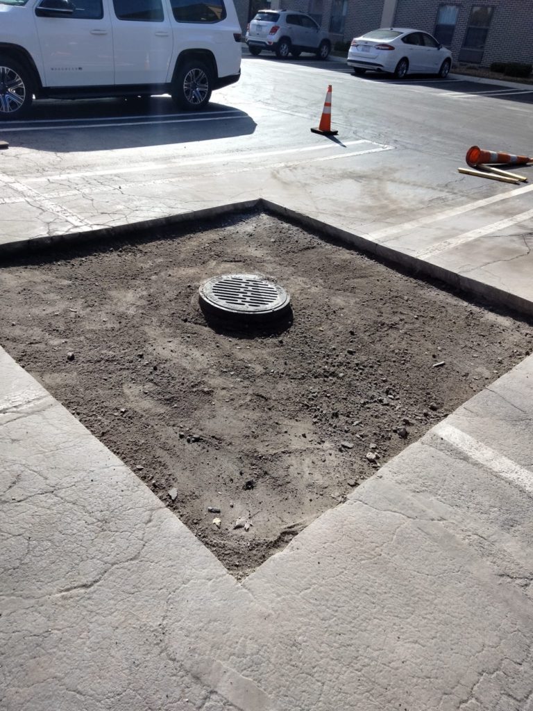 Preparing a commercial parking lot section to be filled with concrete.