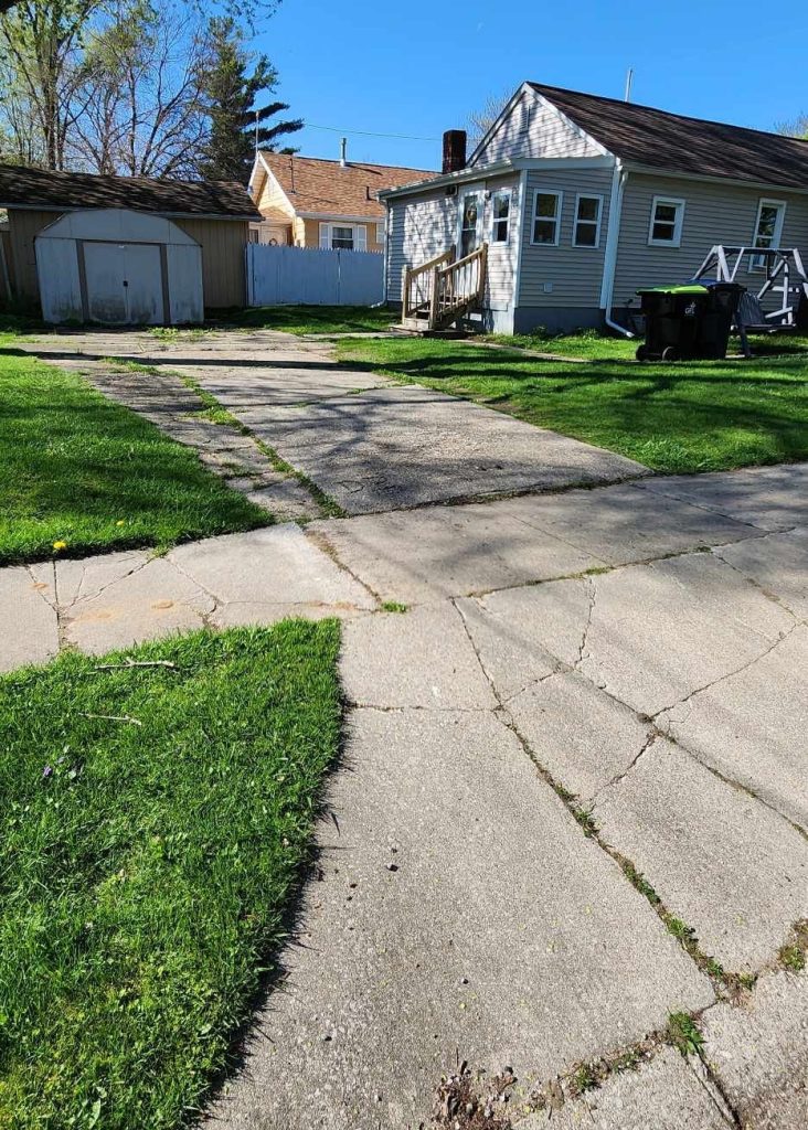 Before picture of a home driveway before renovation.