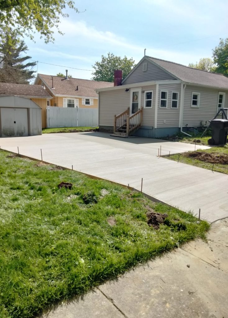 Picture of a home driveway with finished concrete.