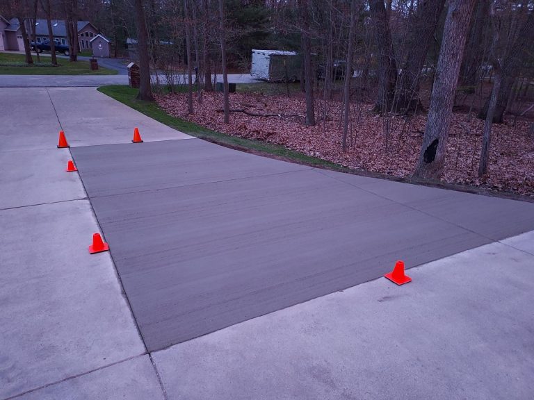 Picture of a home driveway with finished concrete.